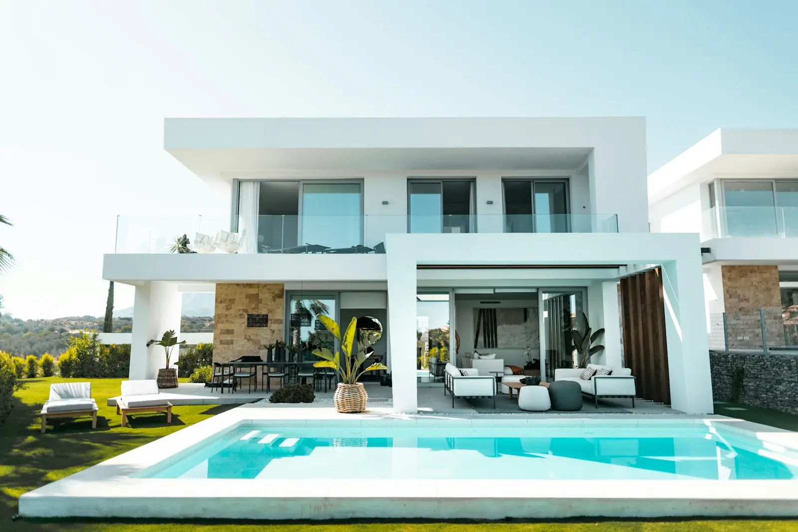 A modern white villa with a swimming pool